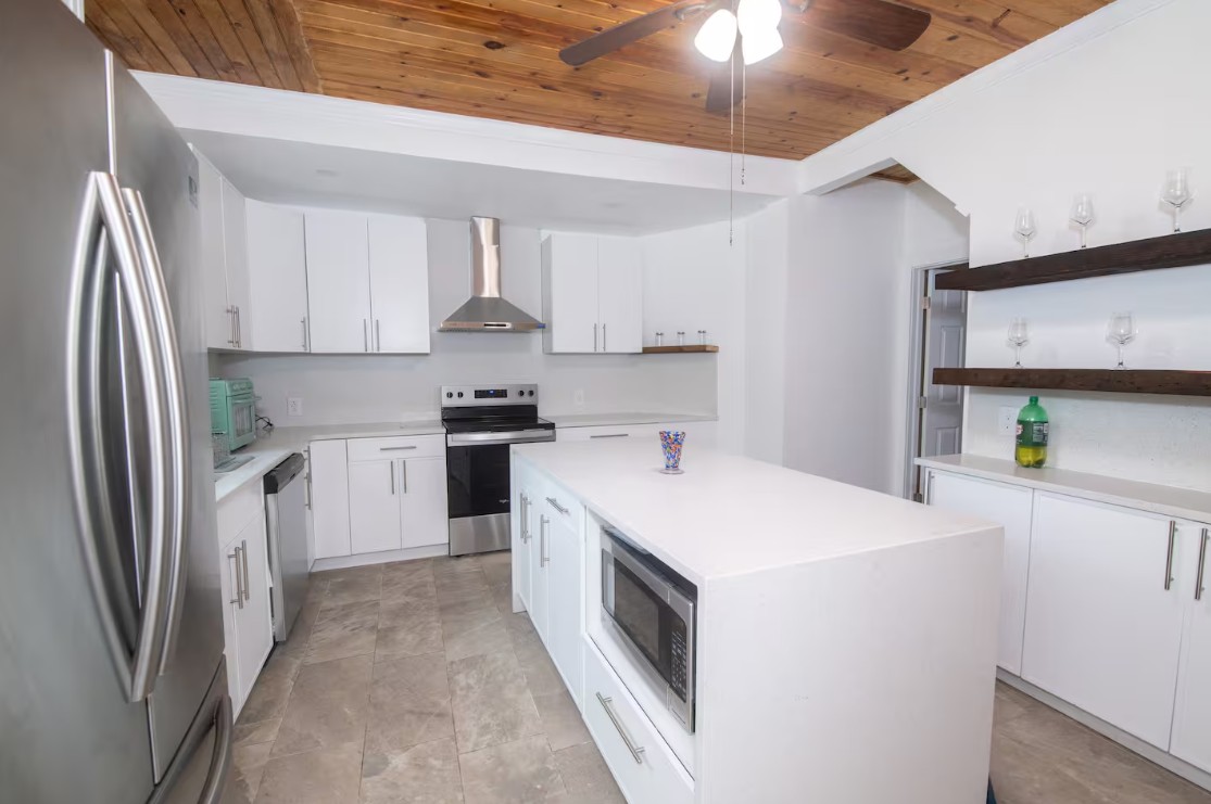 219 Summit kitchen with white cabinets and wood ceiling