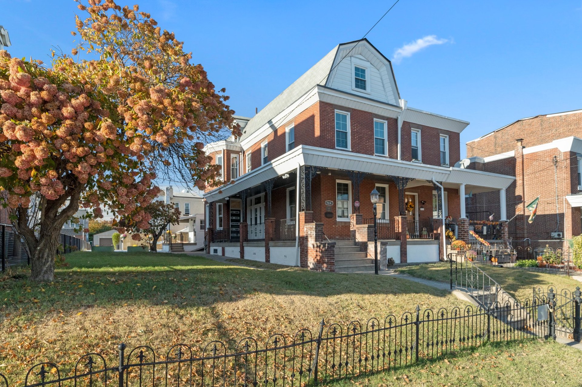 Brick twin home with autumn foliage