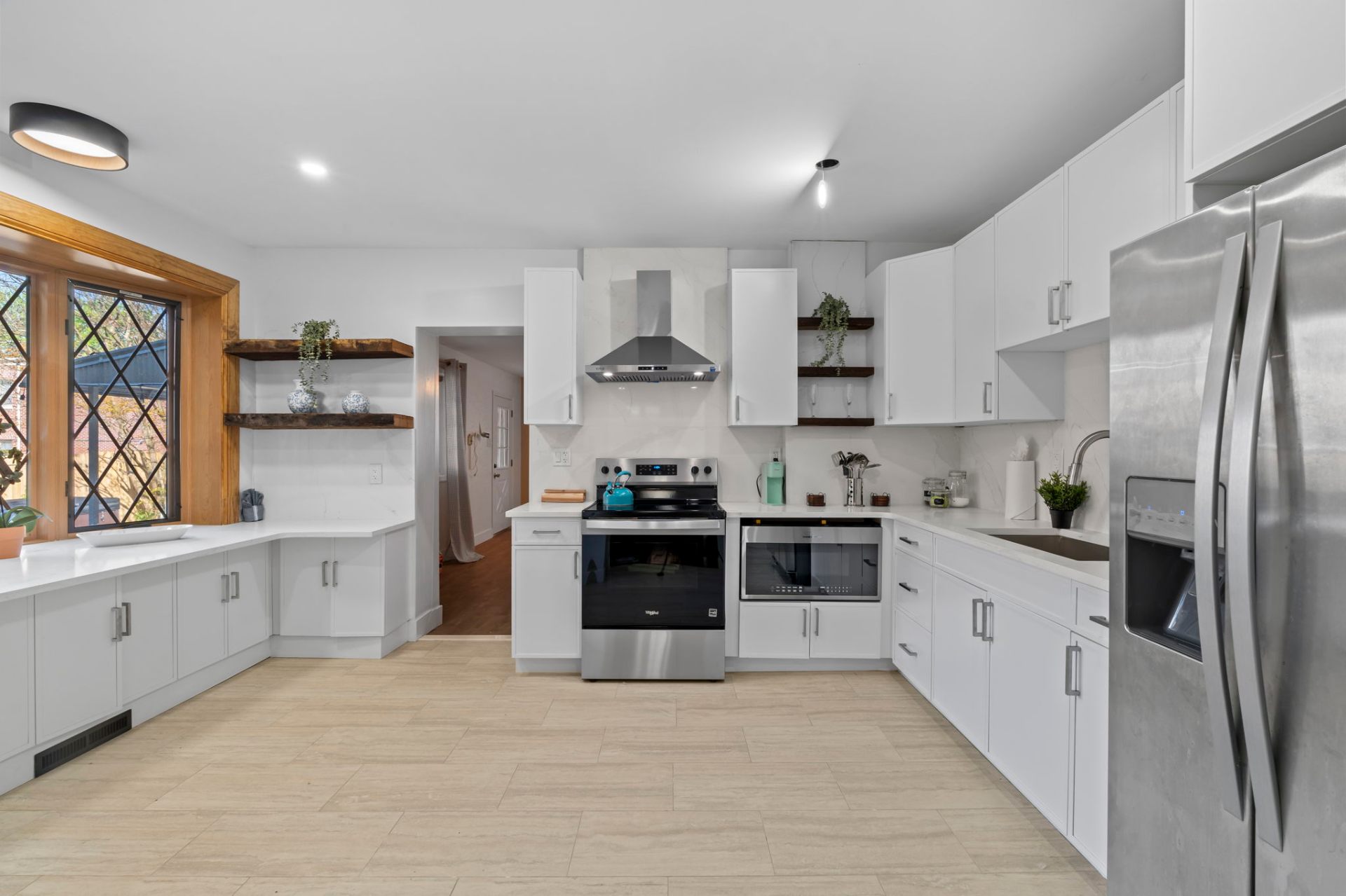 Bright white kitchen with live-edge wood shelves