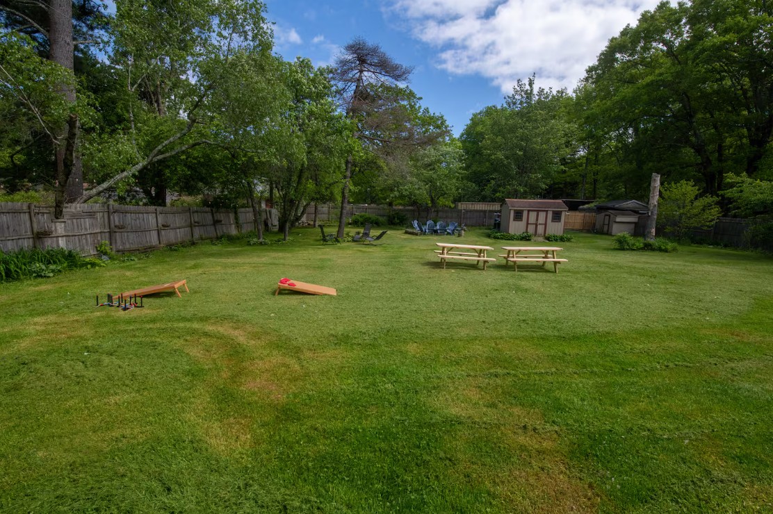 219 Summit backyard with cornhole, ladder toss, picnic tables and fire pit seating