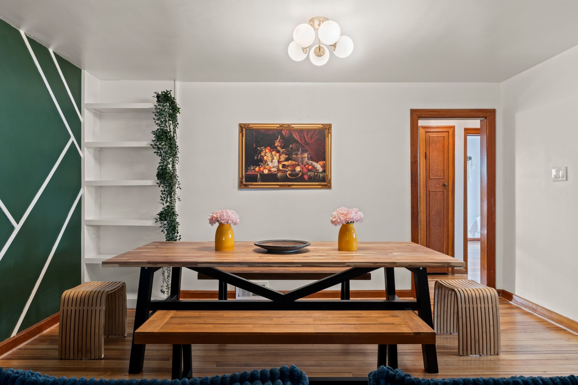 Dining room with wooden table and classical painting