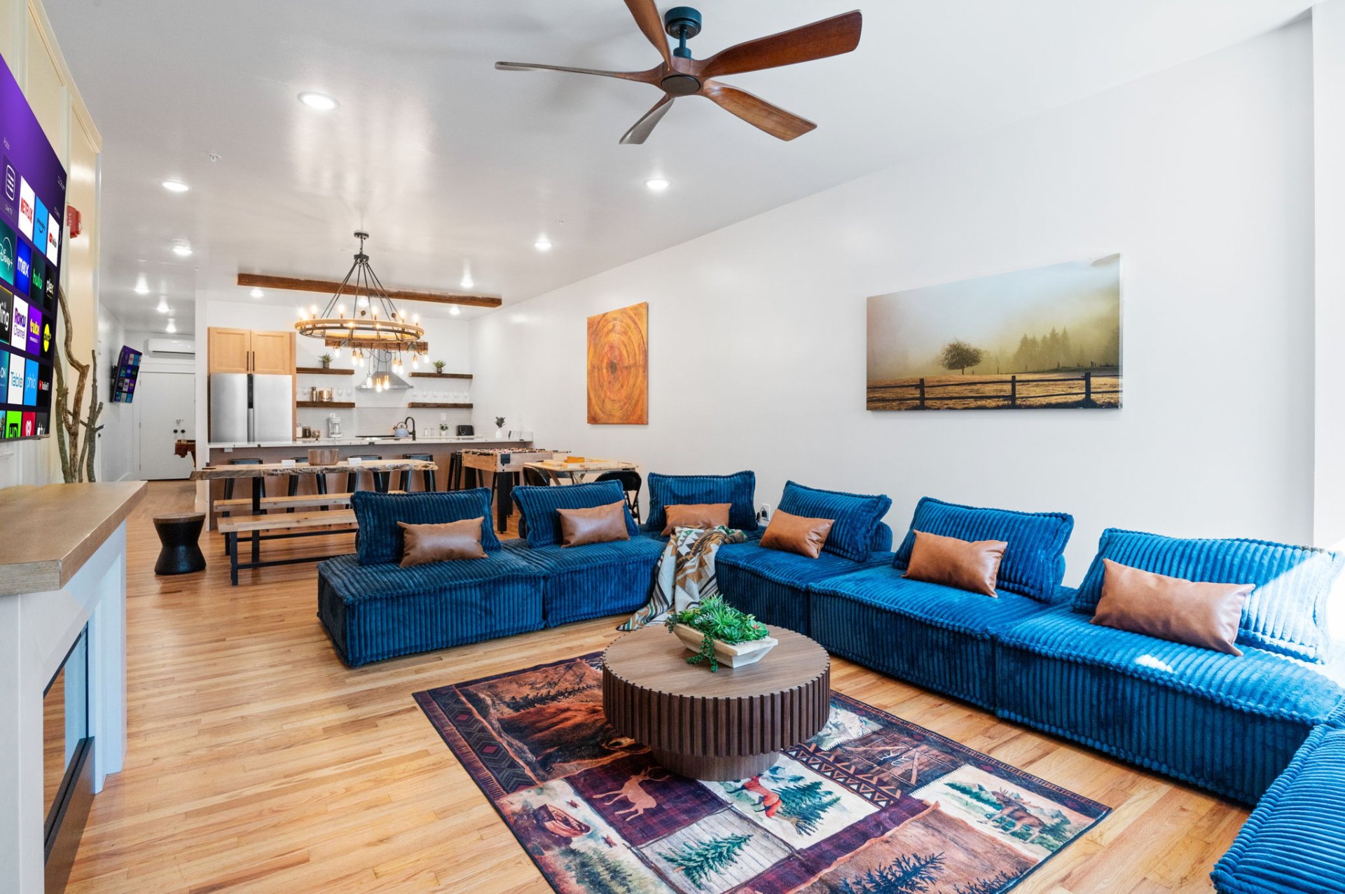 Great room with blue sectional and ceiling fan