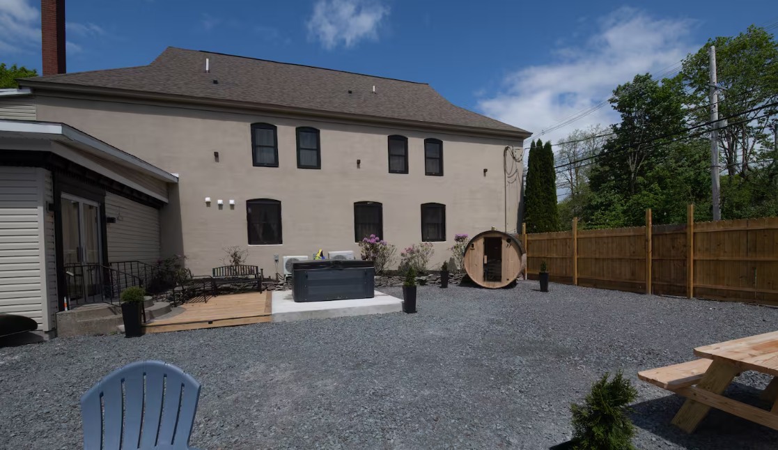 Backyard with hot tub, cedar barrel sauna, patio and picnic seating