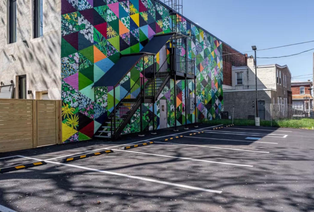 Colorful geometric floral mural on building exterior